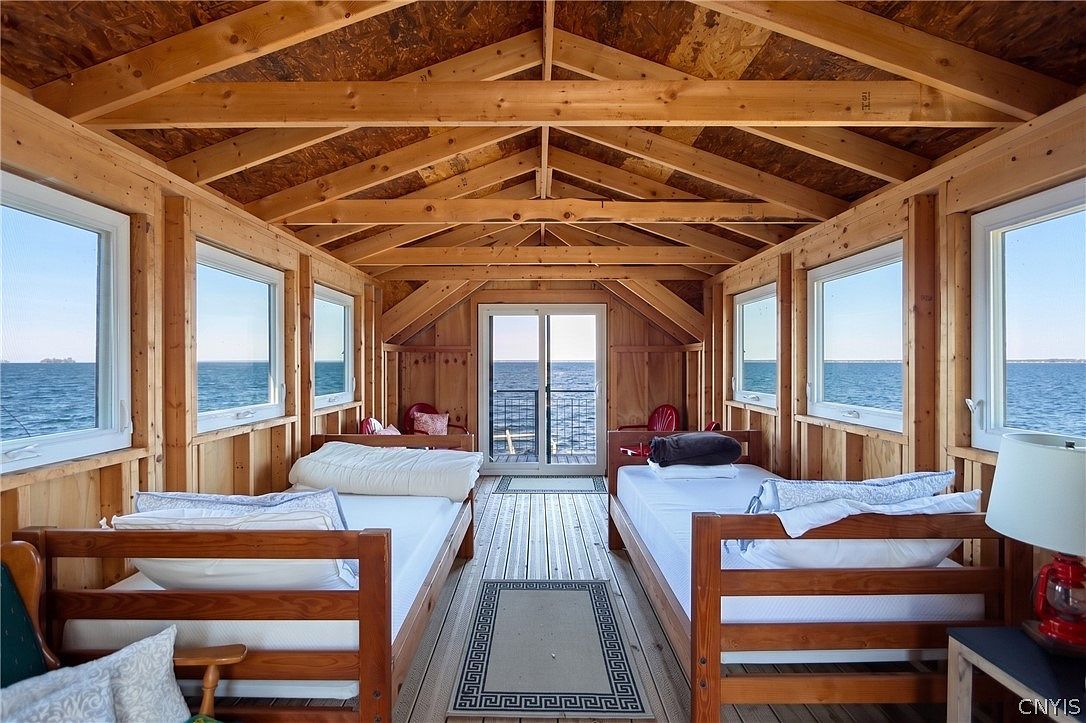 Boathouse loft with two daybeds and windows onto the lake